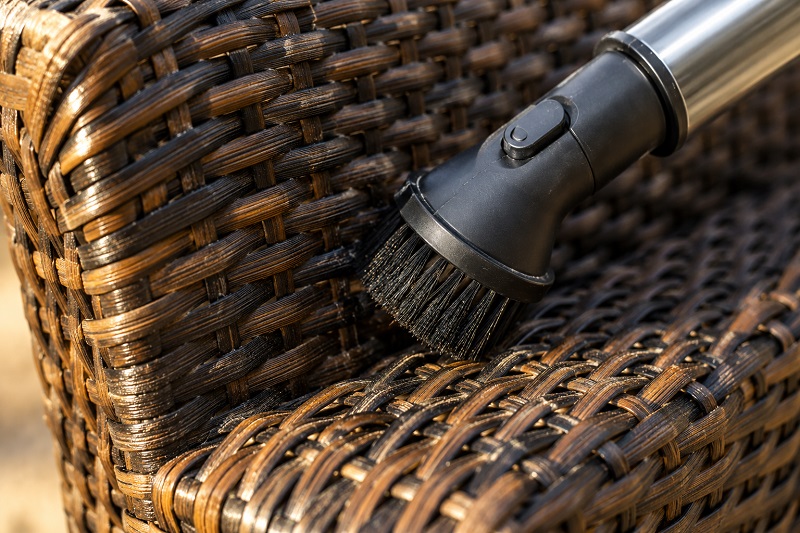 Cleaning woven wicker surface close-up