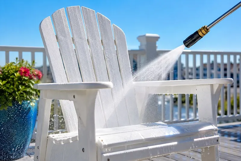 Pressure washing a sunny deck chair